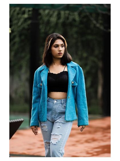 A walking shot that feels candid and captures the attitude of the outfit.