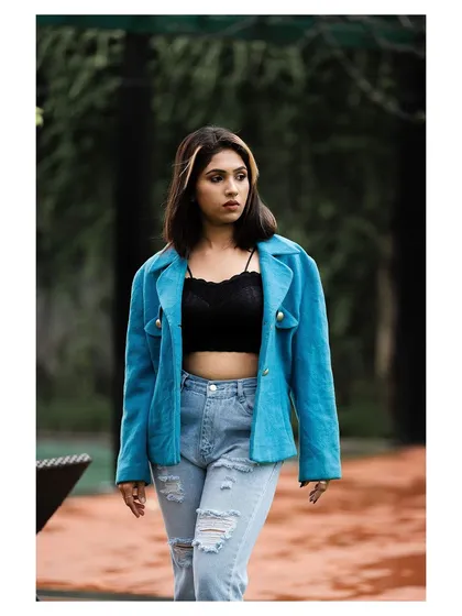 A walking shot that feels candid and captures the attitude of the outfit.