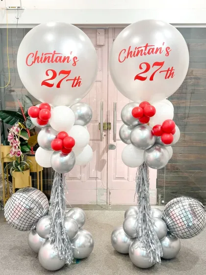 Double the fun for Chintan's 27th! This pair of matching balloon columns in a striking red, white, and silver theme features large personalized balloons and disco balls for a fun, party-ready look.