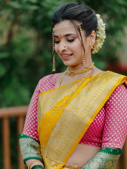 A serene and beautiful portrait. The soft makeup look, paired with a traditional gajra bun, is the epitome of Maharashtrian bridal elegance.