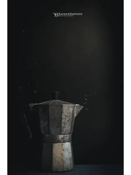 I'm drawn to negative space and minimalism. Here, a single rustic coffee maker is spotlit against a dark, textured background. The floating particles add a bit of magic to this simple, moody composition.