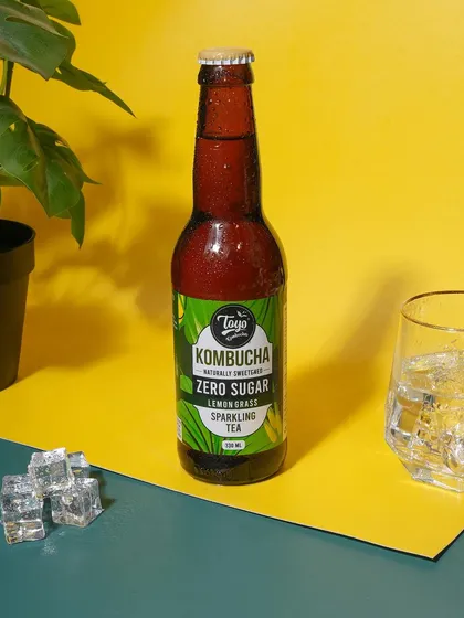 A bold and graphic composition using contrasting color blocks. This modern approach helps the kombucha bottle stand out and grabs attention.