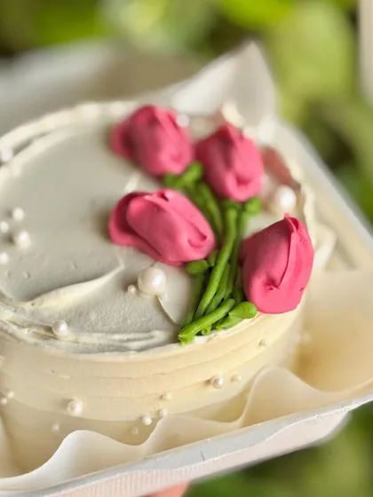 A close-up of the buttercream tulips, showing the delicate piping technique used to create the flower petals.