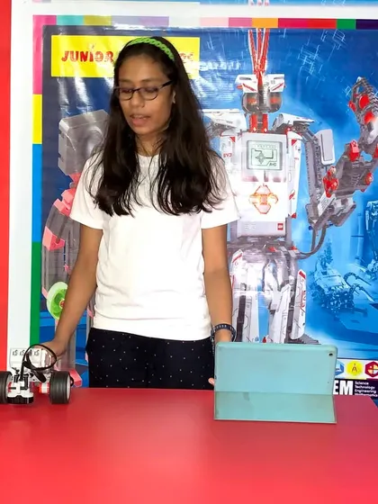 A student presents her line-following robot, a classic project that teaches kids about sensors and autonomous navigation.