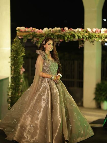 Posing for a portrait at her cocktail event. The lighting highlights the beautiful contour and the shimmer on her gown, creating a truly show-stopping look.
