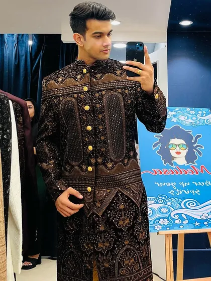 A confident pose in our brown patterned sherwani, captured during a visit to our Kohat Enclave store.