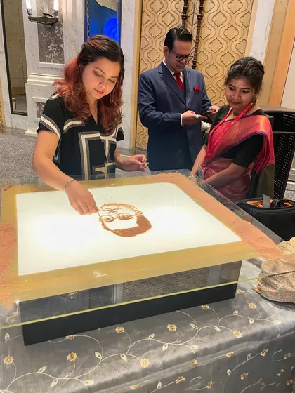 Here I am, focused on the details of a portrait for the Jay Shree Tea event. It's always a joy when guests come up to watch the process up close.