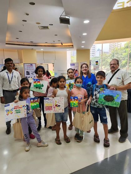 A group of proud kids showing off their finished artwork. The variety of creations is a testament to their individual creativity and imagination.