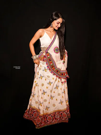 A full-length studio shot for Navratri, showcasing a beautifully embroidered white lehenga, capturing the grace and twirl-ready spirit of the festival.