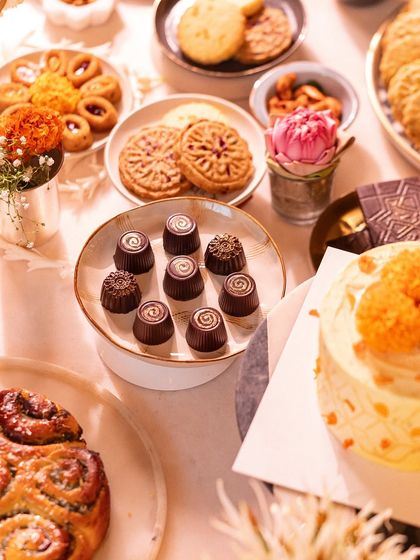 An artful arrangement of our Diwali sweets, including Lonavala Chocolate Bonbons, Maska Mawa Cakes, and a pull-apart babka, all ready for a celebration.