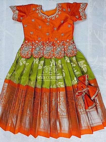 This 6-month-old size Kanchi Pattu lehenga is ready to ship. It features a beautiful orange blouse with silver maggam work.