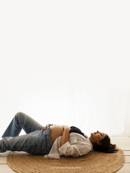 A moment of pure serenity. This minimalist shot, with its clean white background, focuses entirely on the peaceful connection between mother and baby.