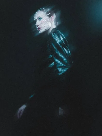 A full-body shot with motion blur, giving the pearl makeup an ethereal, ghost-like quality. This image shows how the makeup contributes to the overall mood of a high-fashion photograph.
