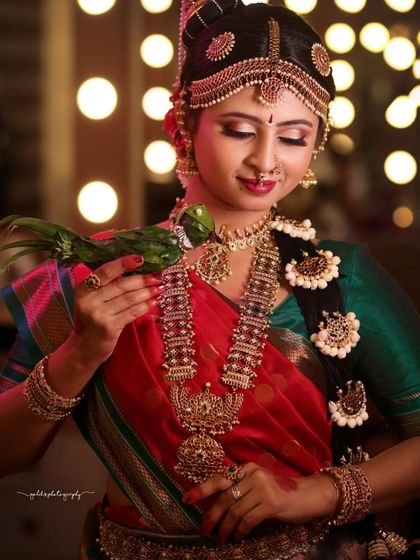 Another shot from the Iyengar bridal series, this one capturing a tender moment with the parrot prop, highlighting the bride's gentle expression.