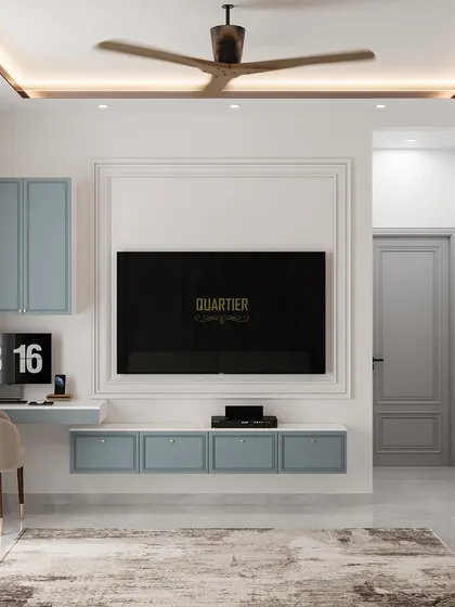 The TV and workstation area of the European-Scandinavian master bedroom. The design uses clean lines, classic trim molding around the TV, and pastel blue cabinetry for a light and airy feel.