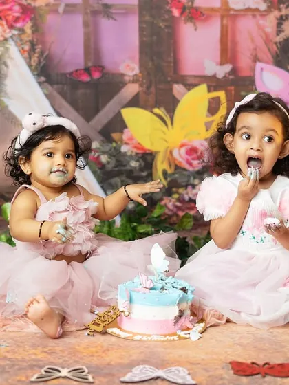 Sharing is caring, especially when it comes to birthday cake. These two sisters are having a wonderful time together.