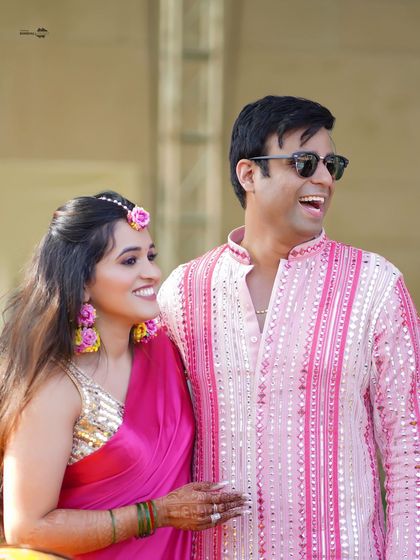 A candid, happy portrait of the couple. Their relaxed smiles and the natural outdoor setting create a warm and inviting photograph.