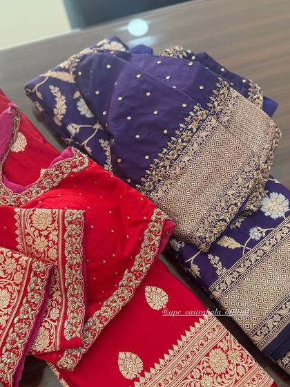 A collection of red and purple blouses, showing the variety of zardosi designs.