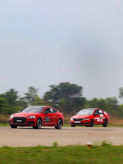 Two red sedans racing neck and neck down the quarter-mile. The close finishes and intense rivalries are what make every race at Vroom an unforgettable experience.