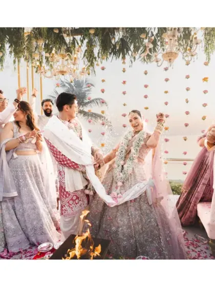 A wide shot of the pheras, capturing the sacred fire, the couple, and their families watching with joy. This image tells the story of two families coming together.