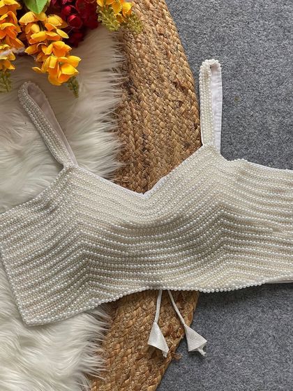 The white pearl moti spaghetti blouse, a timeless and elegant choice that pairs well with any saree.