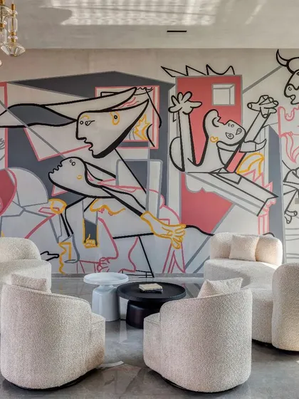 We were given a simple yet profound brief: "Picasso would be proud." Our response was this reimagining of his anti-war masterpiece, 'Guernica,' for a modern residential lounge. This hand-painted mural transforms a powerful historical statement into a personal, contemporary piece that anchors the room with its bold lines and emotional depth.