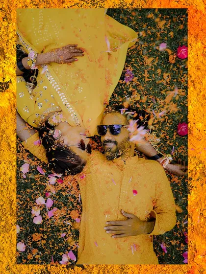 I love finding unique angles. This top-down shot from a Haldi ceremony, with the couple surrounded by marigold petals, creates a vibrant and artistic memory of this colorful tradition.