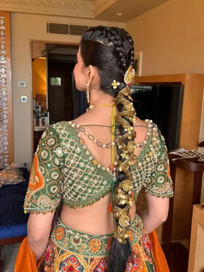 A clear, well-lit shot of a traditional bridal braid with intricate gold jewellery. This hairstyle is a testament to classic Indian bridal beauty, designed to be the crowning glory of the look.