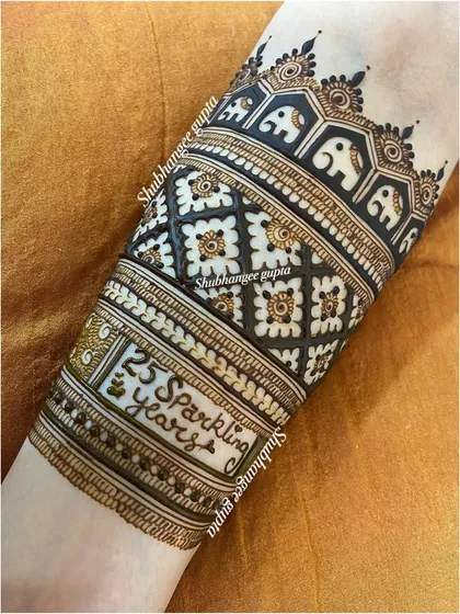 I was honored to create this piece for a client's 25th wedding anniversary. We included the text '25 Sparkling Years' in a special band on her arm, surrounded by celebratory elephant motifs.