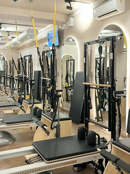Our reformers are lined up and ready for your next class. The mirrored walls help you check your form and alignment as our instructors guide you through each movement.