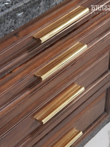 A close-up of the Kiah pulls on a set of drawers, highlighting their clean lines and how they complement the wood grain.