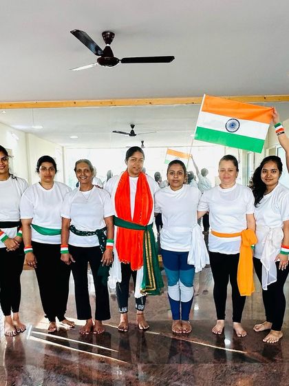 Another group of students celebrating Independence Day at the studio. The tricolor sashes add a beautiful touch to our shared practice.