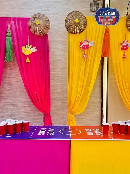 To make the festivities more interactive, I included a fun juice pong game station that matched the bright pink and yellow decor of this Mehendi event.