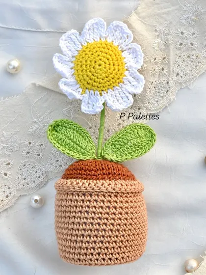 Our full-size potted crochet daisy, a charming piece of decor that brings the freshness of a garden indoors, forever.
