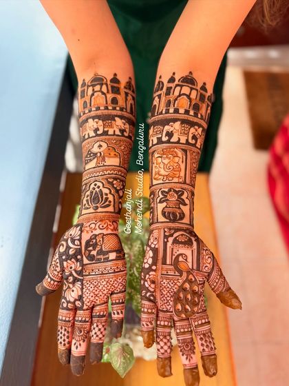 This design for a bride from Canada incorporates classic Indian motifs like the Taj Mahal, elephants, and peacocks, telling a story of heritage.