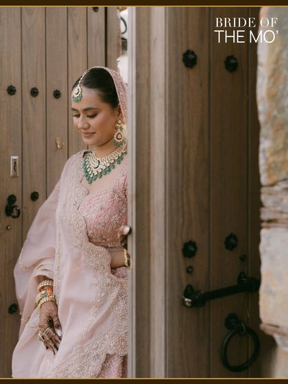 A quiet, elegant portrait of the bride peeking out from behind a wooden door. The "Bride of The Mo'" branding adds a signature touch to this timeless image.