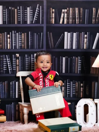 For the little bookworm's first birthday, this library-themed studio setup is a unique and charming option. The 'ONE' letters add a celebratory touch to this creative portrait.