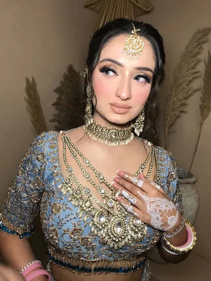 This angle shows the maang tikka and earrings, completing the full bridal jewelry set.