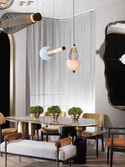 A dynamic arrangement of Luna Kaleido pendants at the India Design Fair, showcasing a variety of glass shapes and colors. This image emphasizes the endless customization options available.