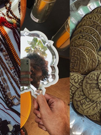 A selfie in a vintage silver-plated mirror, surrounded by antique beads and coins.