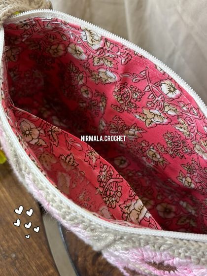 A peek inside reveals a beautiful floral lining and a handy inner pocket, ensuring your belongings are safe and organized.