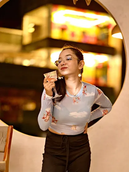 A guest enjoying a fresh cocktail at Lumara. The combination of good music and great drinks is key to the JU:CY experience.