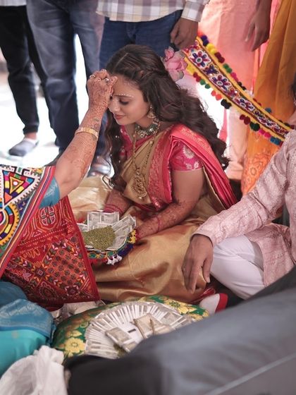 A sacred moment during the Ganesh Poojan. The bride's devotional look is completed with a traditional bindi.