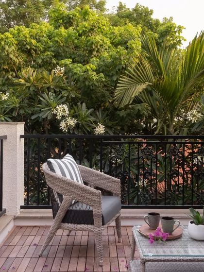 An all-weather wicker chair on a client's balcony. While I specialize in teak, I also source complementary pieces to complete indoor-outdoor spaces.