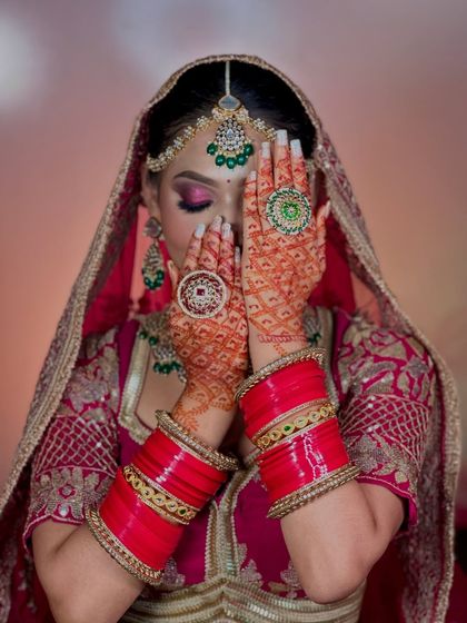 A close-up of the eye makeup and henna. The soft, shimmery eyeshadow and perfectly winged liner are key elements of this look.