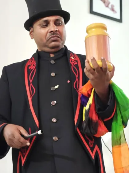 Preparing for a classic illusion with a vase, a magic wand, and a colorful silk handkerchief. These are the timeless tools of a magician.