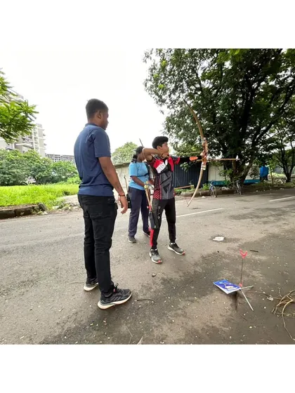 A young archer practices his shot under my supervision. We create a supportive environment where students can build their skills and confidence with every arrow they shoot.