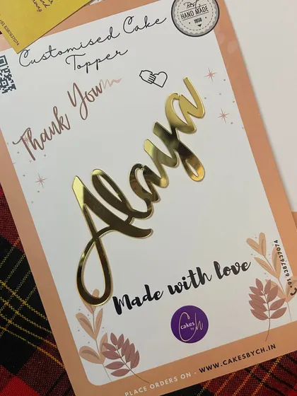 The "Alaya" topper on its backing card, showing how each piece is "Made with love."