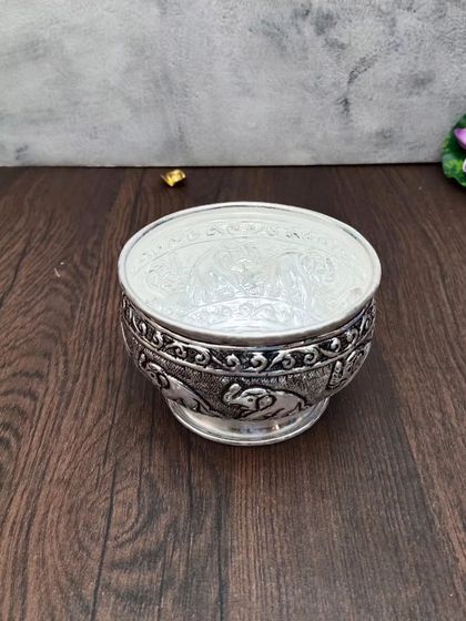 Another view of the antique elephant bowl, a versatile piece for decoration or serving.