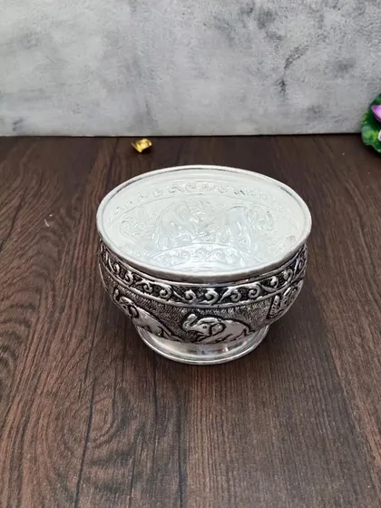 Another view of the antique elephant bowl, a versatile piece for decoration or serving.